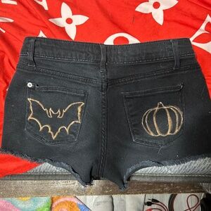 Black high-calf shoes and black shorts